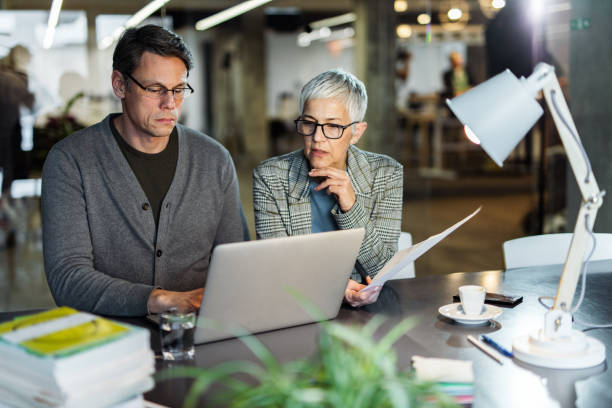 istock Two entrepreneurs cooperating while making plans on laptop in the office. 1188190796