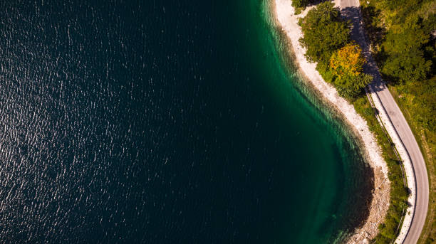 istock Road and Forest at Lake Edge. Top Down Aerial Drone View 1188192719