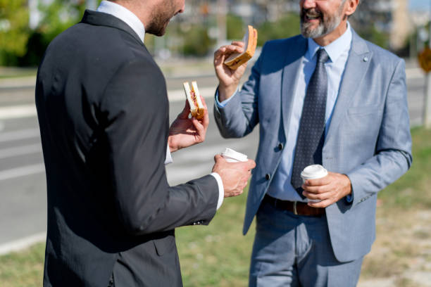 istock Two businessmen eating lunch on the go 1188195550