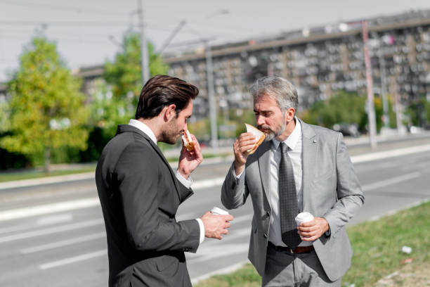 istock Two businessmen eating lunch on the go 1188196253