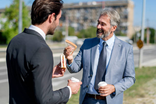 istock Two businessmen eating lunch on the go 1188196315
