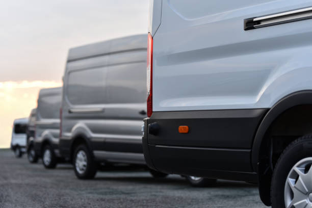 cargo vans cargo vans of delivery service on parking light commercial vehicle stock pictures, royalty-free photos & images