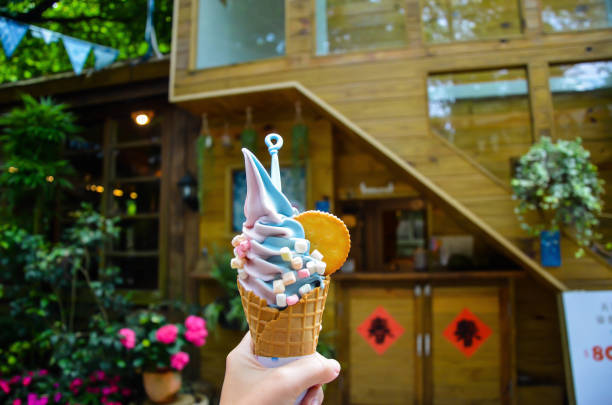 Miaoli, Taiwan - APR 14, 2019: Hand holding ice cream in Zhuo ye cottage.