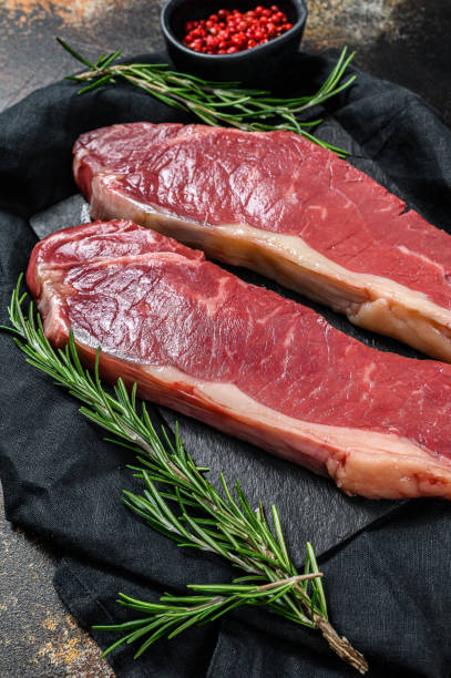 istock Fresh meat, marbled beef, raw sirloin steak. Dark background. Flat lay 1188203865