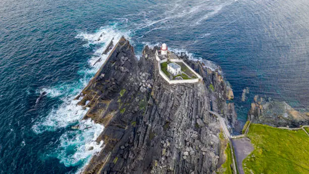 Photo of Beautiful view of Valentia Island Lighthouse at Cromwell Point. Locations worth visiting on the Wild Atlantic Way. Scenic Irish countyside on sunny summer day, County Kerry, Ireland.