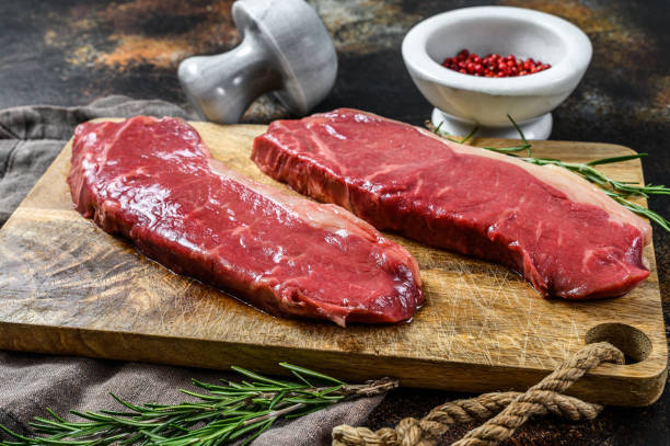 istock Raw ramp steak, fresh meat, marbled beef. Dark background. Flat lay 1188204952