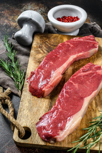 istock Raw ramp steak, fresh meat, marbled beef. Dark background. Flat lay 1188204989