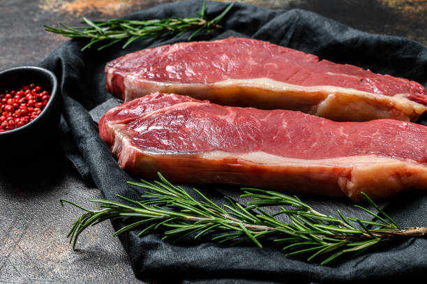 istock Raw ramp steak, fresh meat, marbled beef. Dark background. Flat lay 1188205081