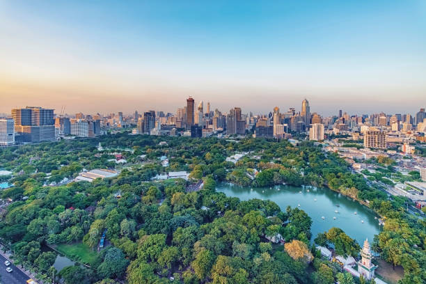 Bangkok city in daytime Lumphini Park and skyscrapers in Bangkok city, Thailand silom stock pictures, royalty-free photos & images