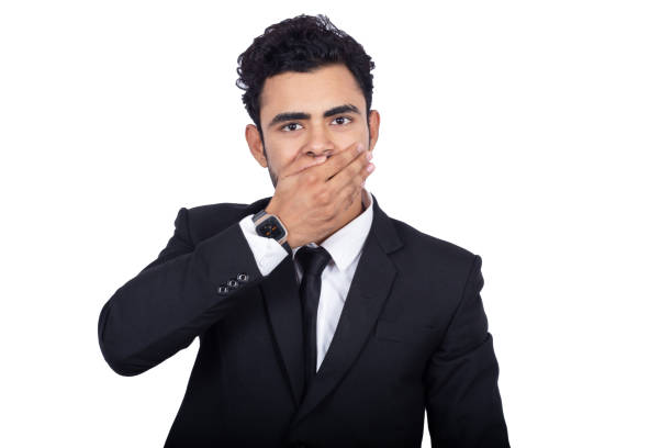 porträt eines indischen geschäftsmannes, der seinen mund mit händen vor weißem hintergrund bedeckt - overworked worried distraught front view stock-fotos und bilder