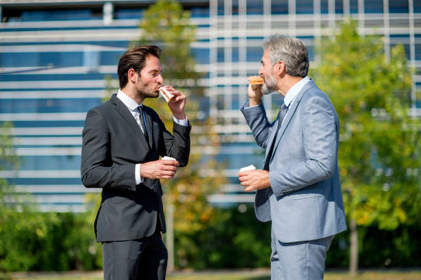 istock Two businessmen eating lunch on the go 1188211451