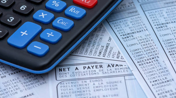 french payroll with social contributions along with a calculator - tax financial figures analyzing banking document imagens e fotografias de stock