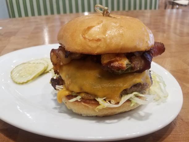 istock hamburger with cheese on plate with bacon and stuffed peppers 1188211920