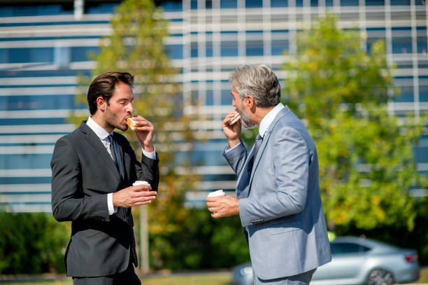 istock Two businessmen eating lunch on the go 1188211961