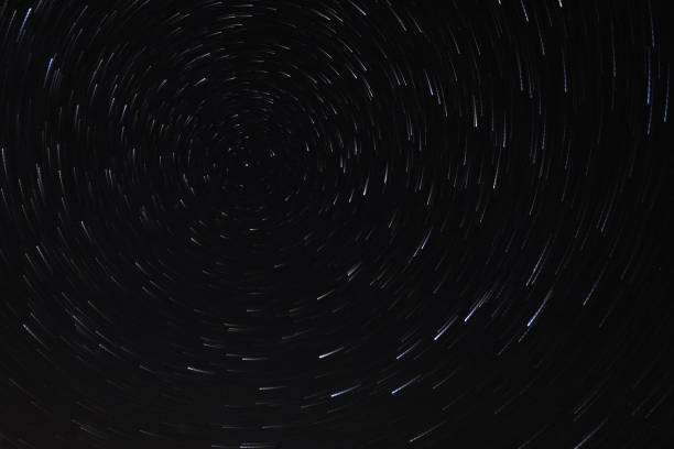 istock Long exposure starry sky, twisted tracks of stars. 1188213100