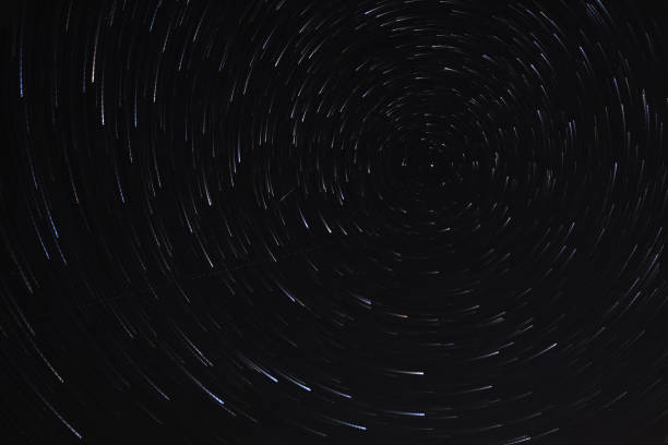 istock Long exposure starry sky, twisted tracks of stars. 1188213103