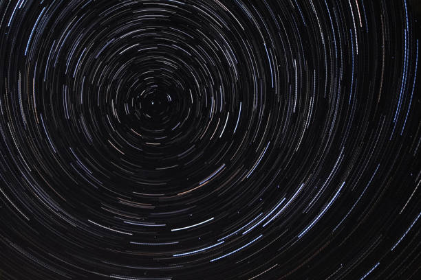 istock Long exposure starry sky, twisted tracks of stars. 1188213117