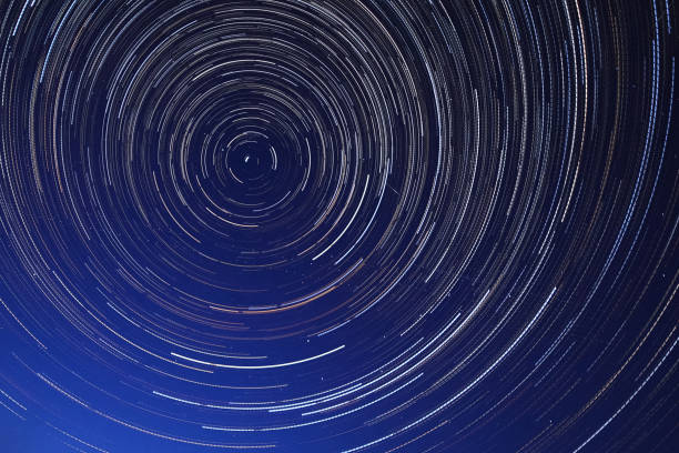 istock Long exposure starry sky, twisted tracks of stars. 1188213124