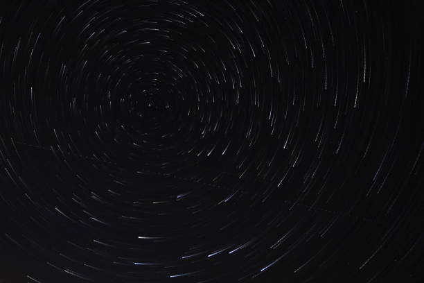 istock Long exposure starry sky, twisted tracks of stars. 1188213128