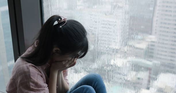 istock woman cry near by window 1188213220