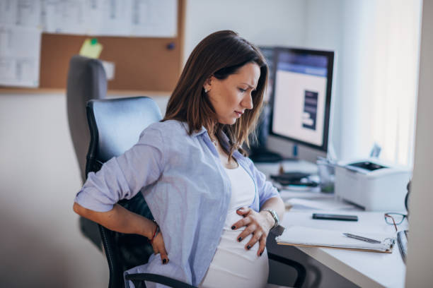 istock Pregnant woman feeling back pain while working 1188213424