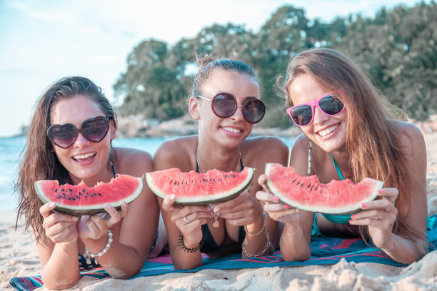 istock Female friends eating watermelon 1188214487