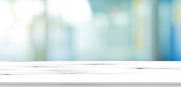 istock blurred inside of interior luxury modern bathroom in the morning panoramic background with white marble pattern tabletop for show, promote ads and design product on display concept 1188216295