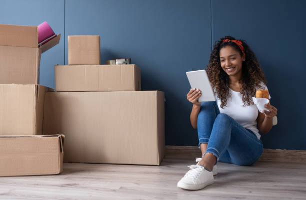 istock Happy woman eating while moving house 1188217261