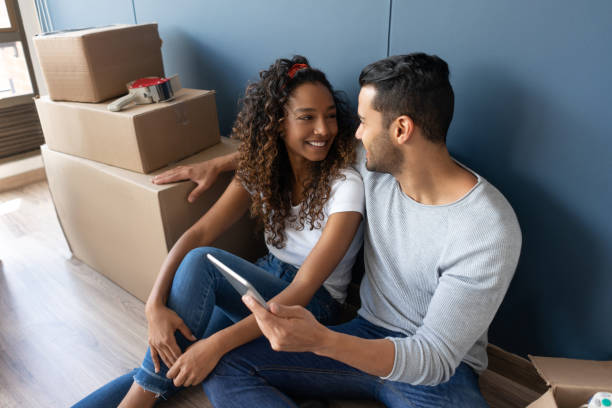 istock Loving couple moving house and taking a break from packing 1188217300