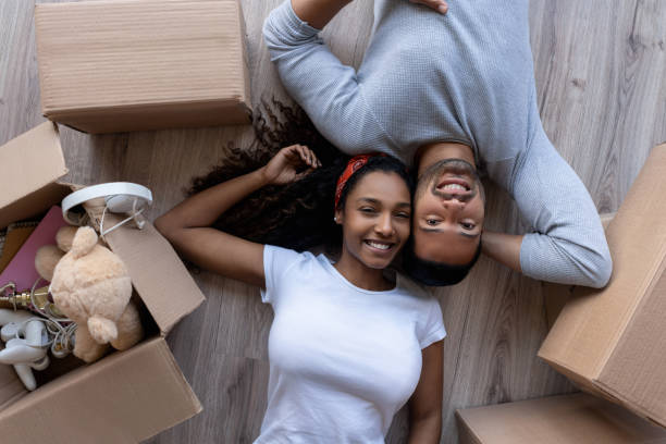 istock Loving couple moving house and packing in boxes 1188217400