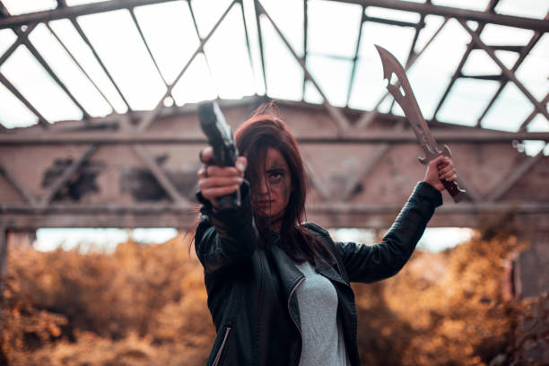 istock Woman warrior with gun and sword 1188219018
