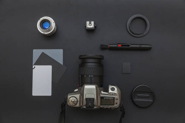 istock Photographer workplace with dslr camera system, camera cleaning kit, lens and camera accessory on dark black table background. Hobby travel photography concept Flat lay top view copy space 1188219166