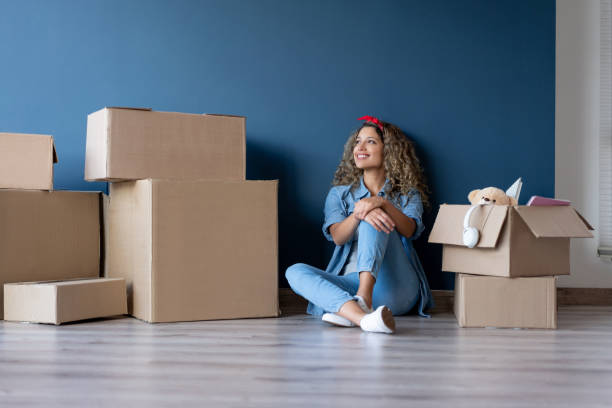 istock Thoughtful woman moving house and packing in boxes 1188220339
