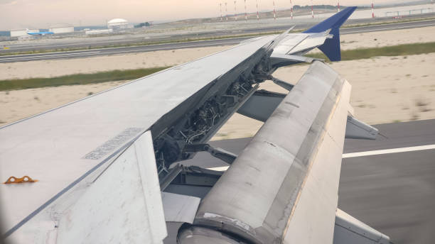 istock Aircraft wing outside board aileron lifting up for maneuvering speed while take off at the airport. 1188220690