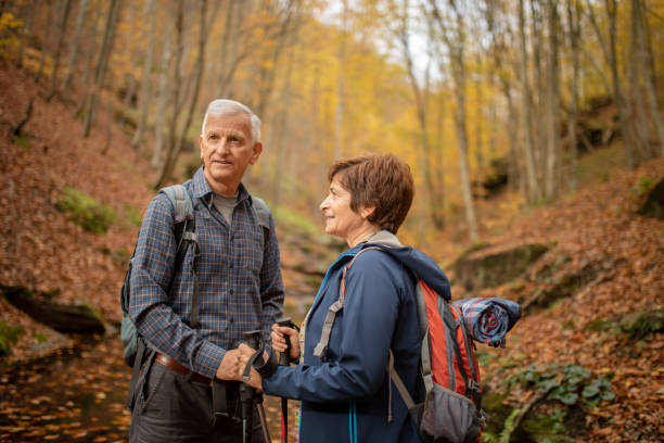 istock Senior couple going hiking in forest on mountain 1188220947