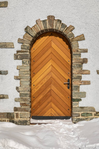 istock Wooden door on white building decorated by brick 1188221993