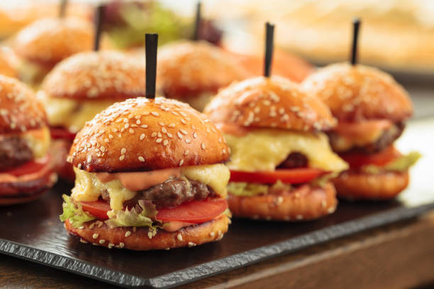 istock Burgers on wooden table in restaurant . 1188222122