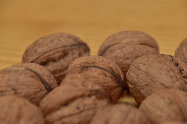istock Walnuts lying on a wooden countertop 1188222133