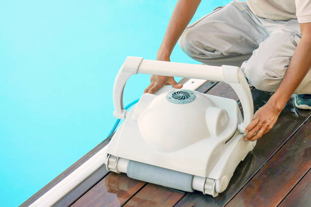 Hotel staff worker cleaning the pool