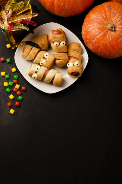 istock Scary sausage mummies in dough with funny eyes 1188225632
