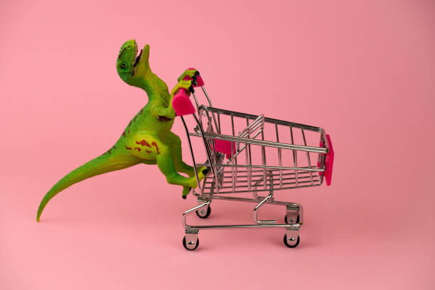 green dinosaur toy with shopping cart