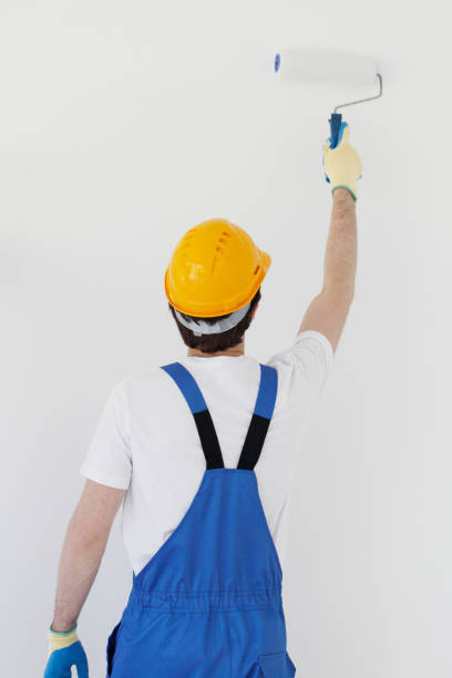 istock Worker painting walls in new house 1188226101