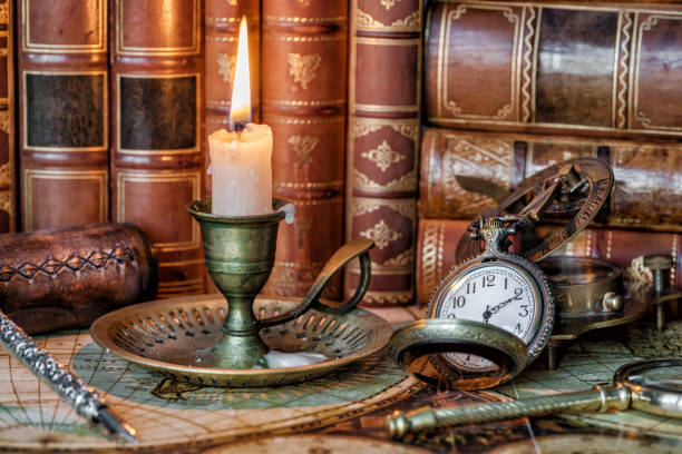 istock Pocket watch, burning candle and old books 1188227641