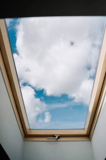 istock Roof Skylight Window and Blue Sky with Clouds 1188228825