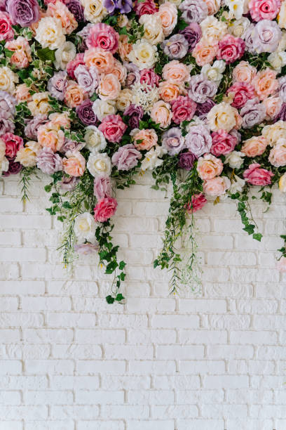 istock Beautiful Decorative Colorful Roses on White Wall 1188230349