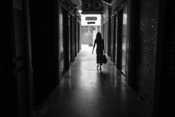 istock defocus woman silhouette walk on small street 1188230764