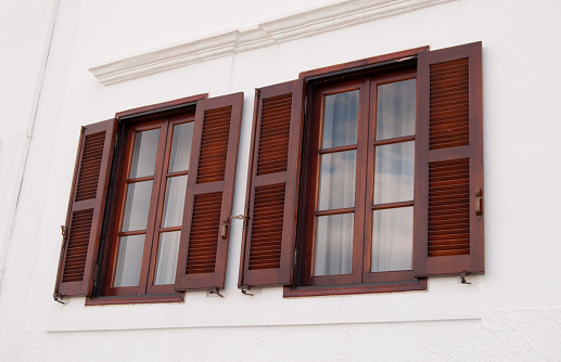 two dark brown wooden windows
