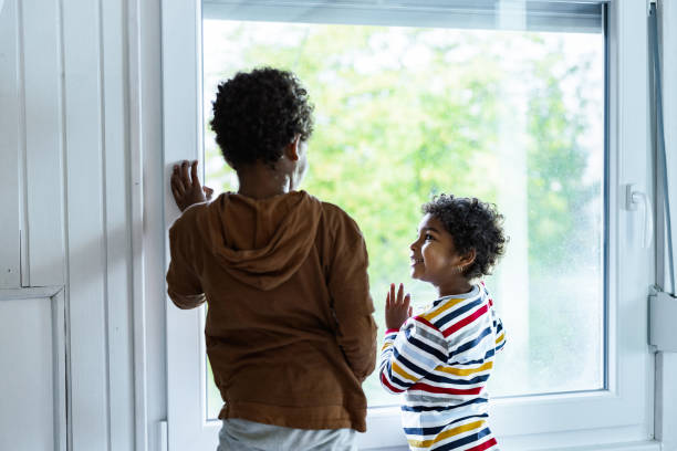 istock Happy African American kids talking by the window. 1188234409
