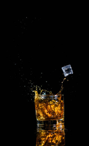 istock Isolated shot of whiskey with splash on black background 1188235218