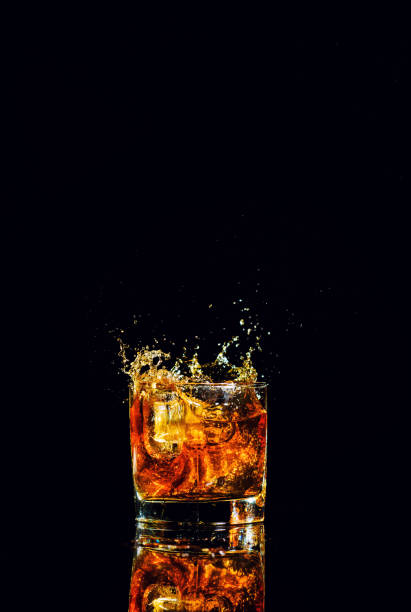 istock Isolated shot of whiskey with splash on black background 1188235236